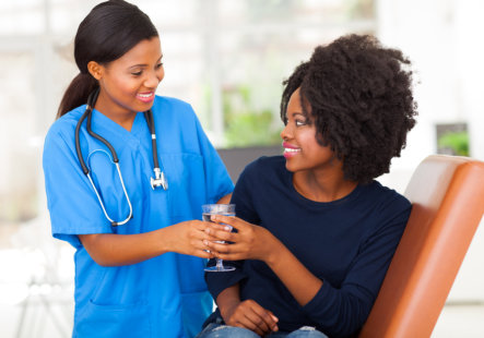 medical nurse give water to patient